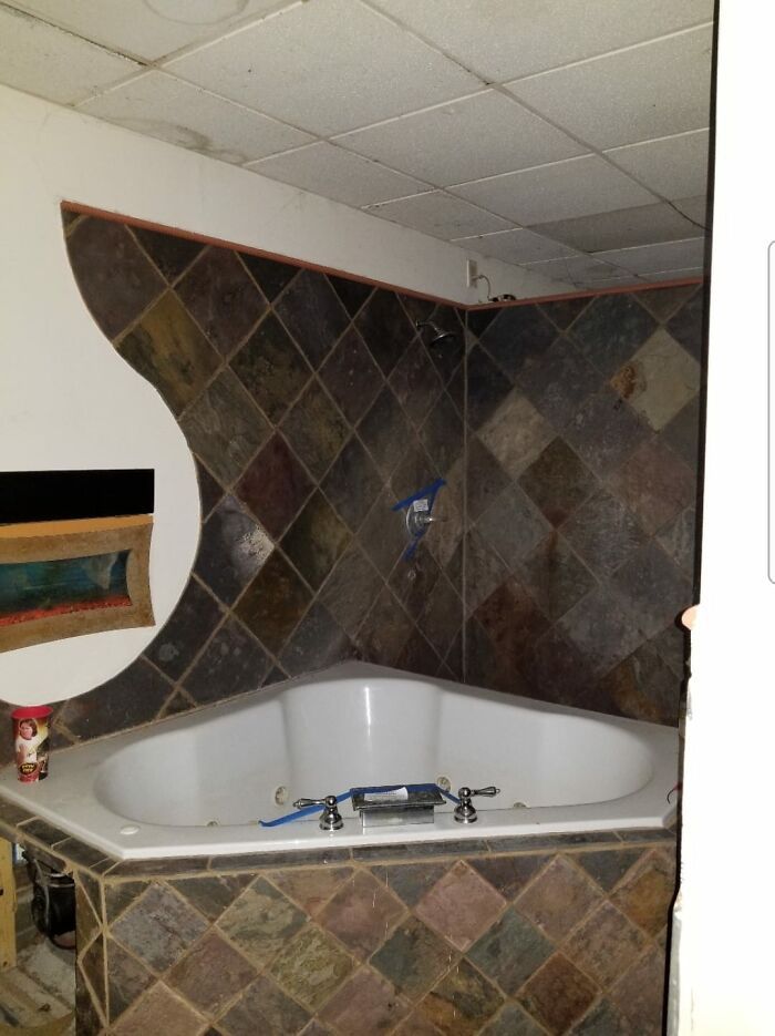 Voici une photo de la salle de bain principale d’une maison que nous avons achetée à la vente aux enchères il y a quelques années. Toute la salle de bain était improvisée et jetée ensemble. zoome sur la gauche, c’est un aquarium dans le mur !