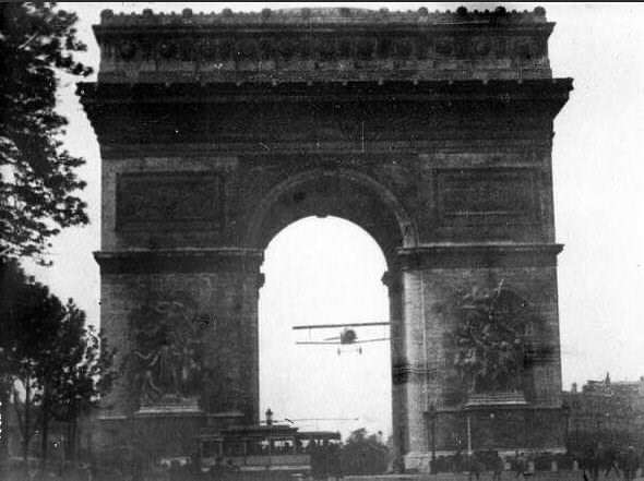 L’aviateur français Charles Godefroy traverse l’arc de triomphe en volant. Paris, 1919.
