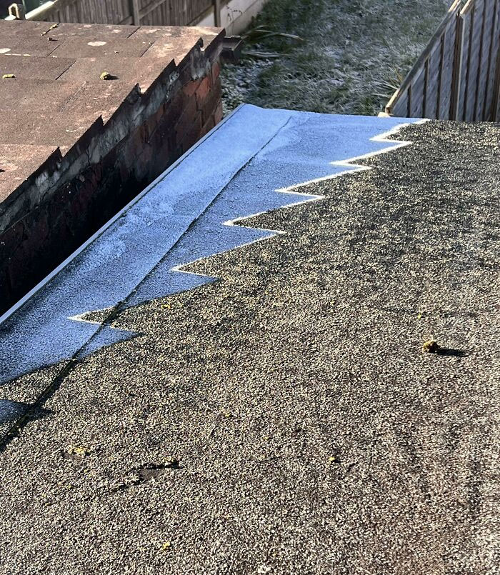 The Shadow Of My Neighbors’ Roof Leaving This Pattern Of Ice On Mine