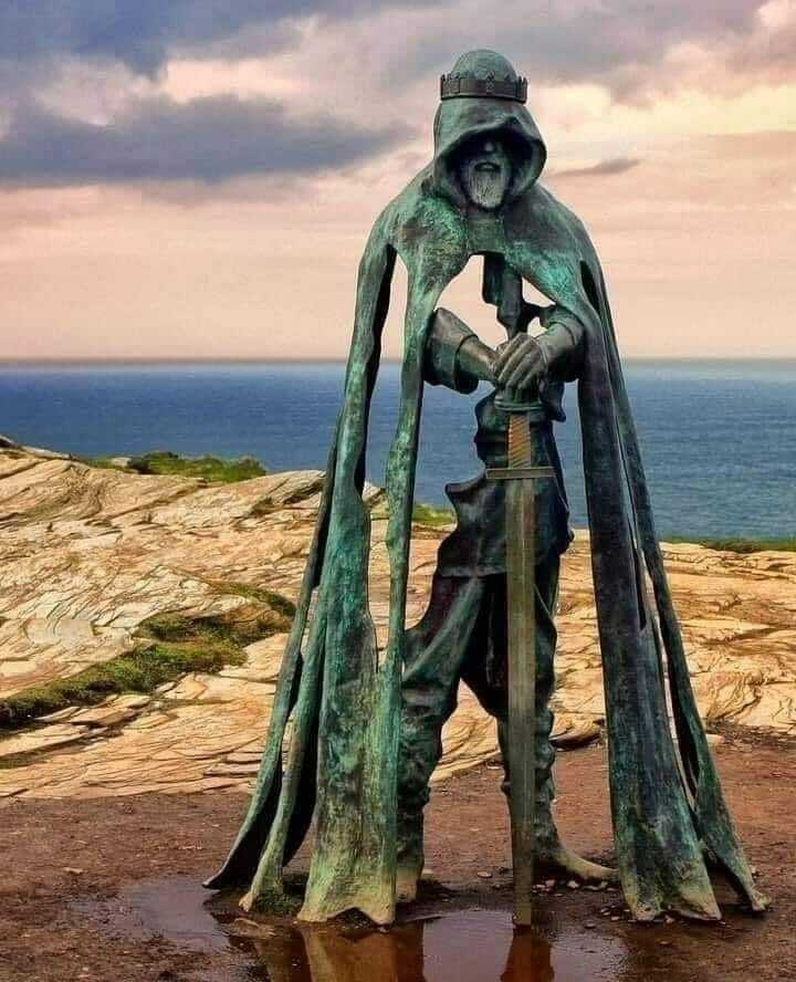 King Arthur’s Statue Overlooking The Atlantic Ocean On The Cliffs Of Tintagel In Cornwall, England