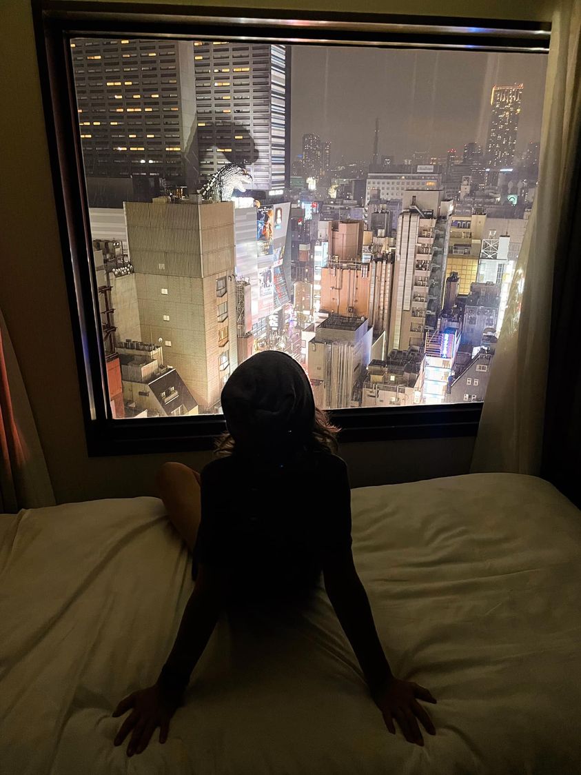 We Just Arrived In Tokyo Two Hours Ago, My Younger Son Is Watching The City From Our Hotel Window. And Yes, That Is A Godzilla There On The Top Of A Building Next To Us