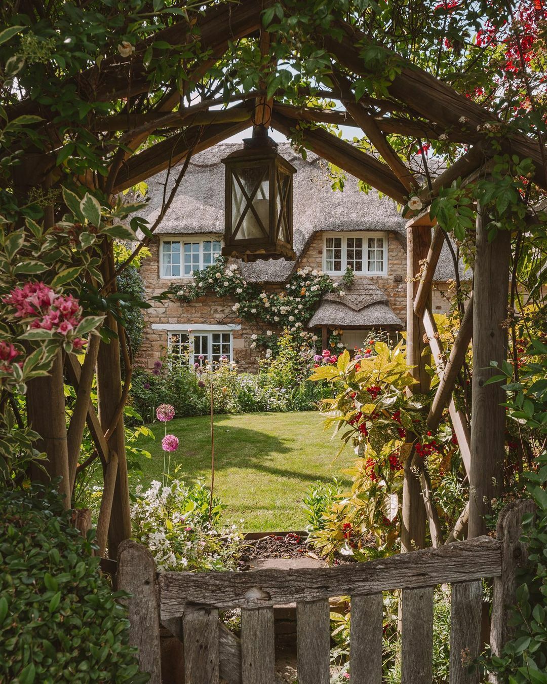 Thatched Roof Cottage Surrounded By Flowers, Rutland, East Midlands, England